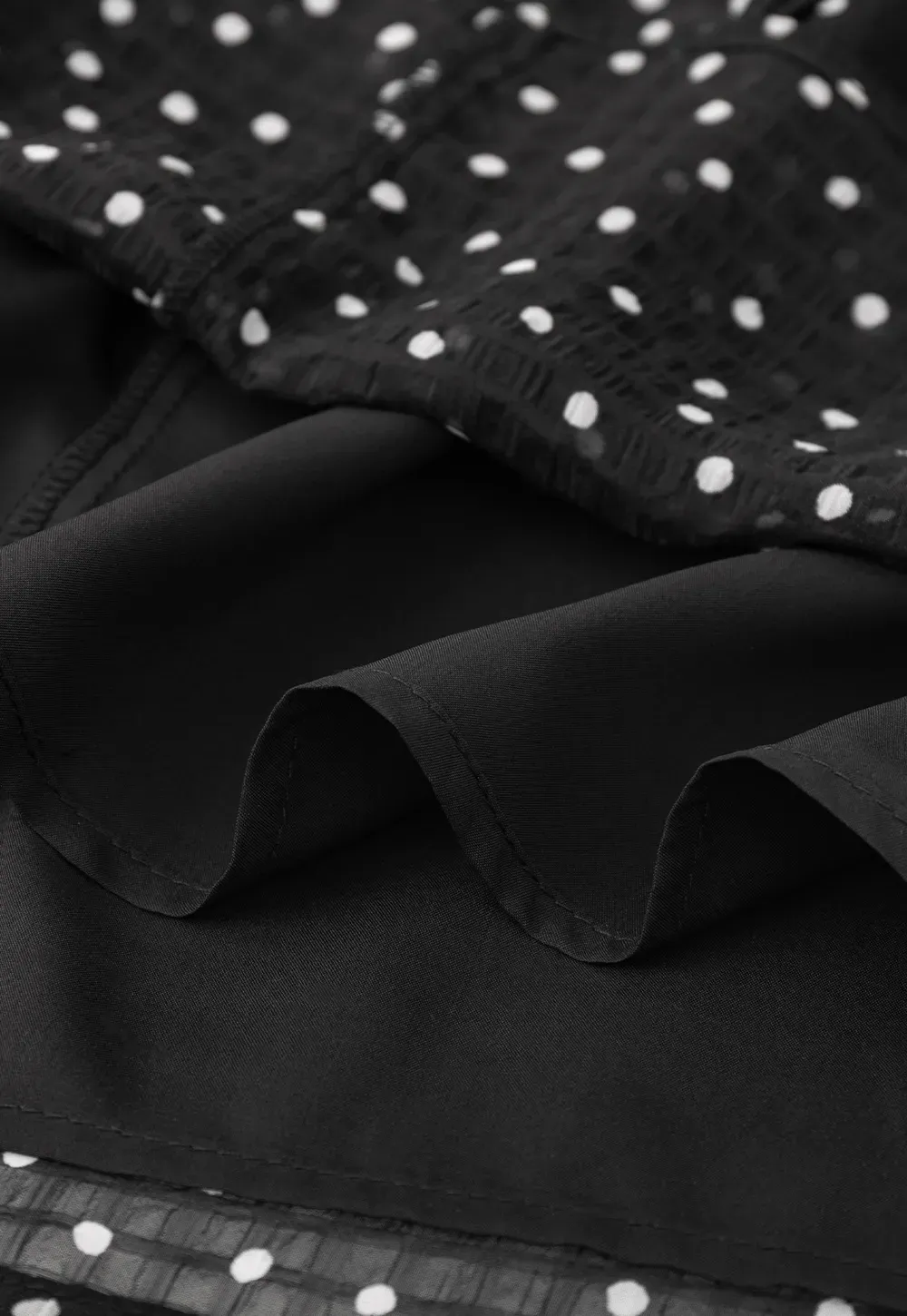 Sheer polka dot blouse with ruffled neckline and long sleeves