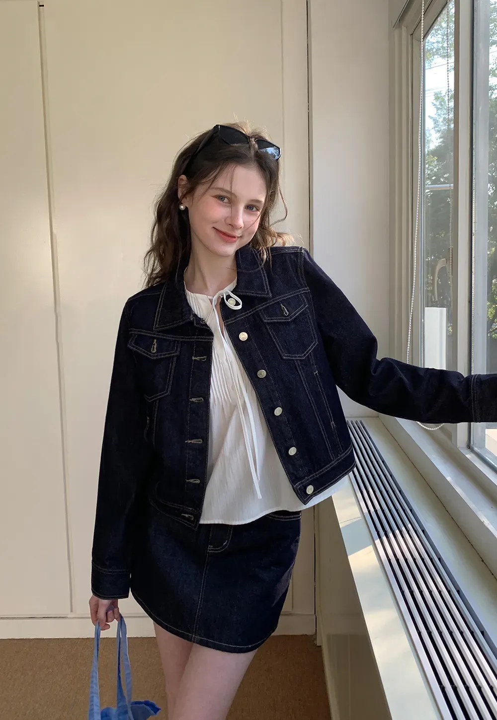 A-line denim skirt with front pocket design and adjustable waistband.