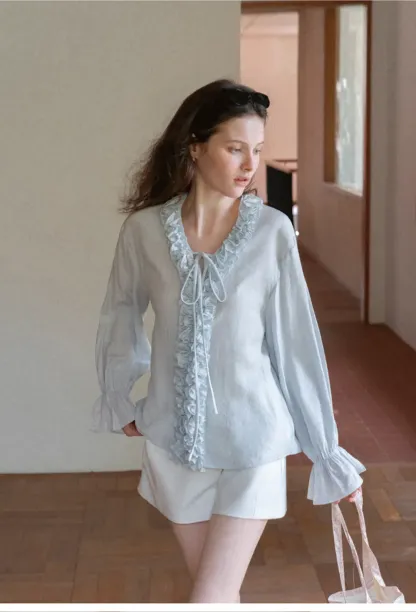 Long sleeve shirt with ruffled neckline and gathered cuffs