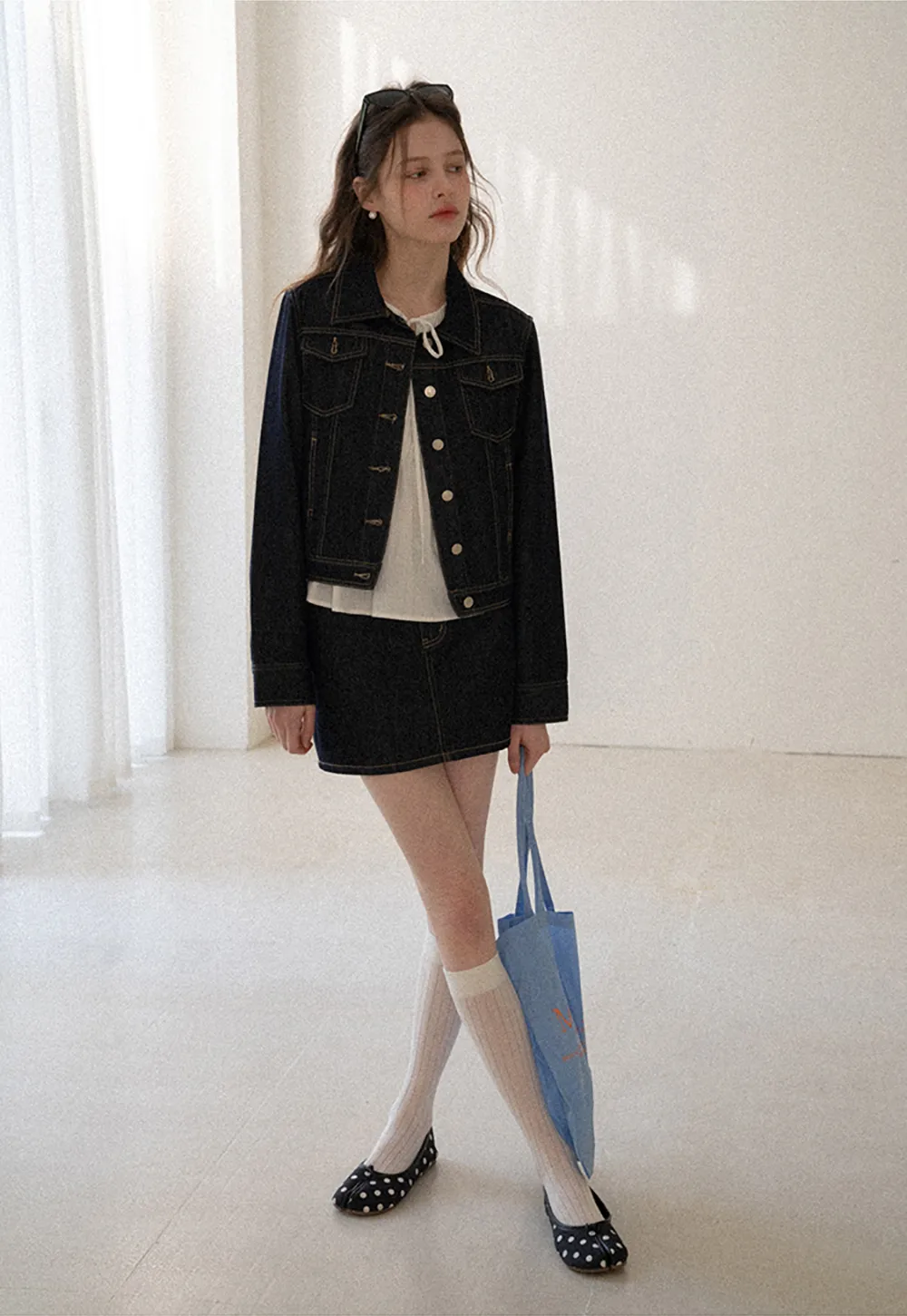 A-line denim skirt with front pocket design and adjustable waistband.