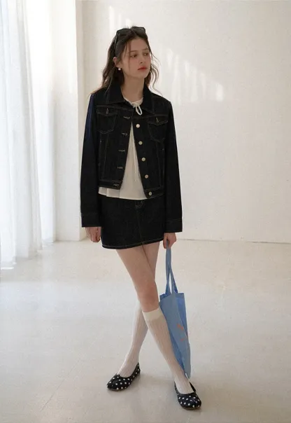 A-line denim skirt with front pocket design and adjustable waistband.