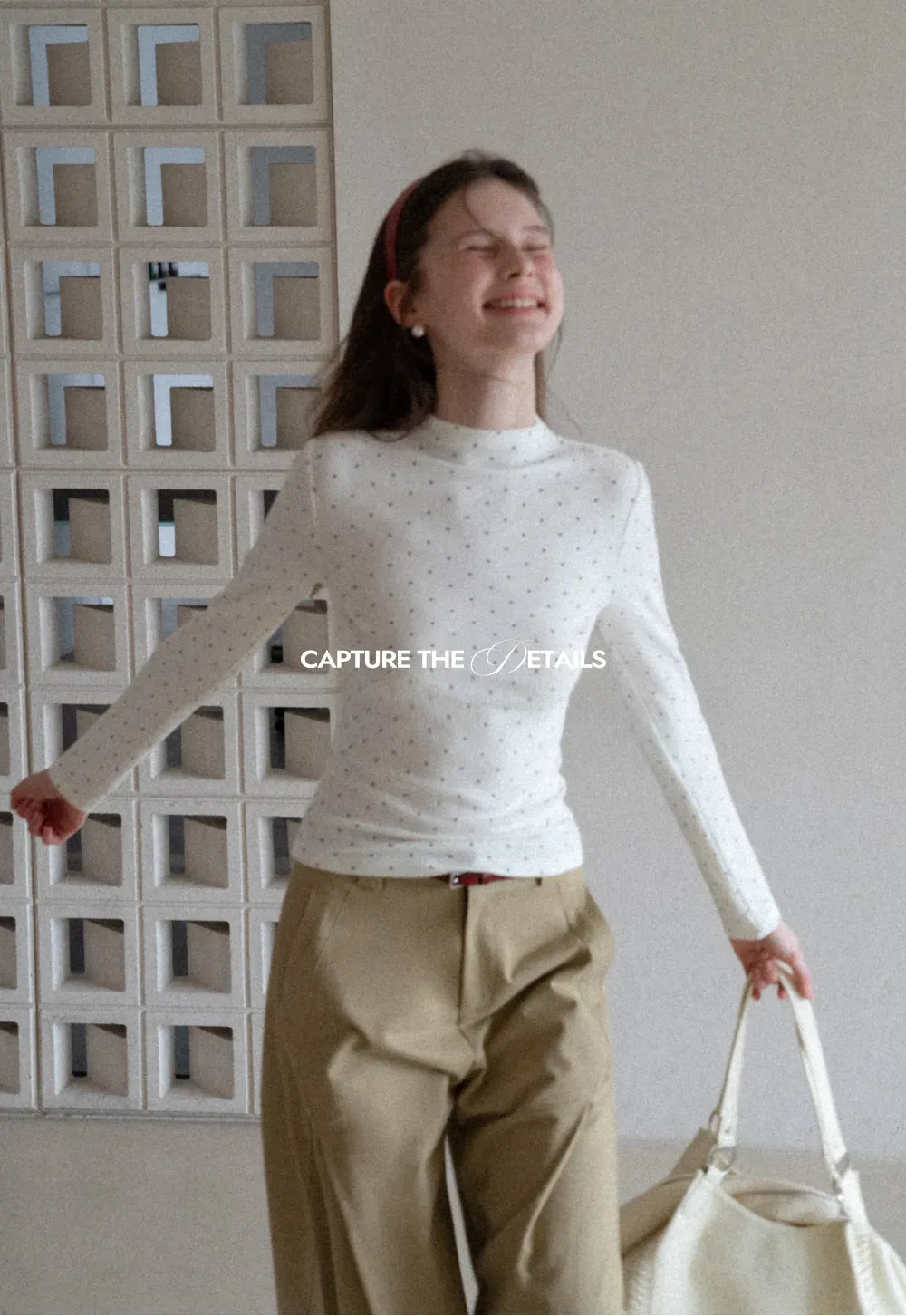 Elegant sleeveless dress with collar layered over polka dot top