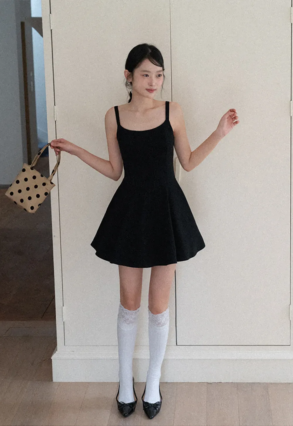 Sleeveless dress with thin straps and flared skirt