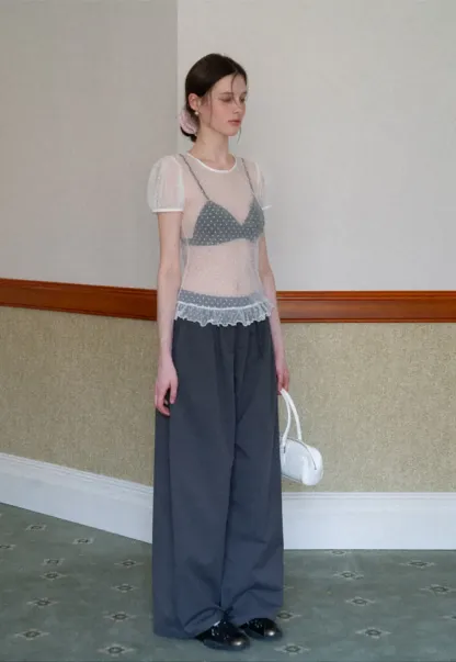 Sheer polka dot top with ruffled hem and puff sleeves