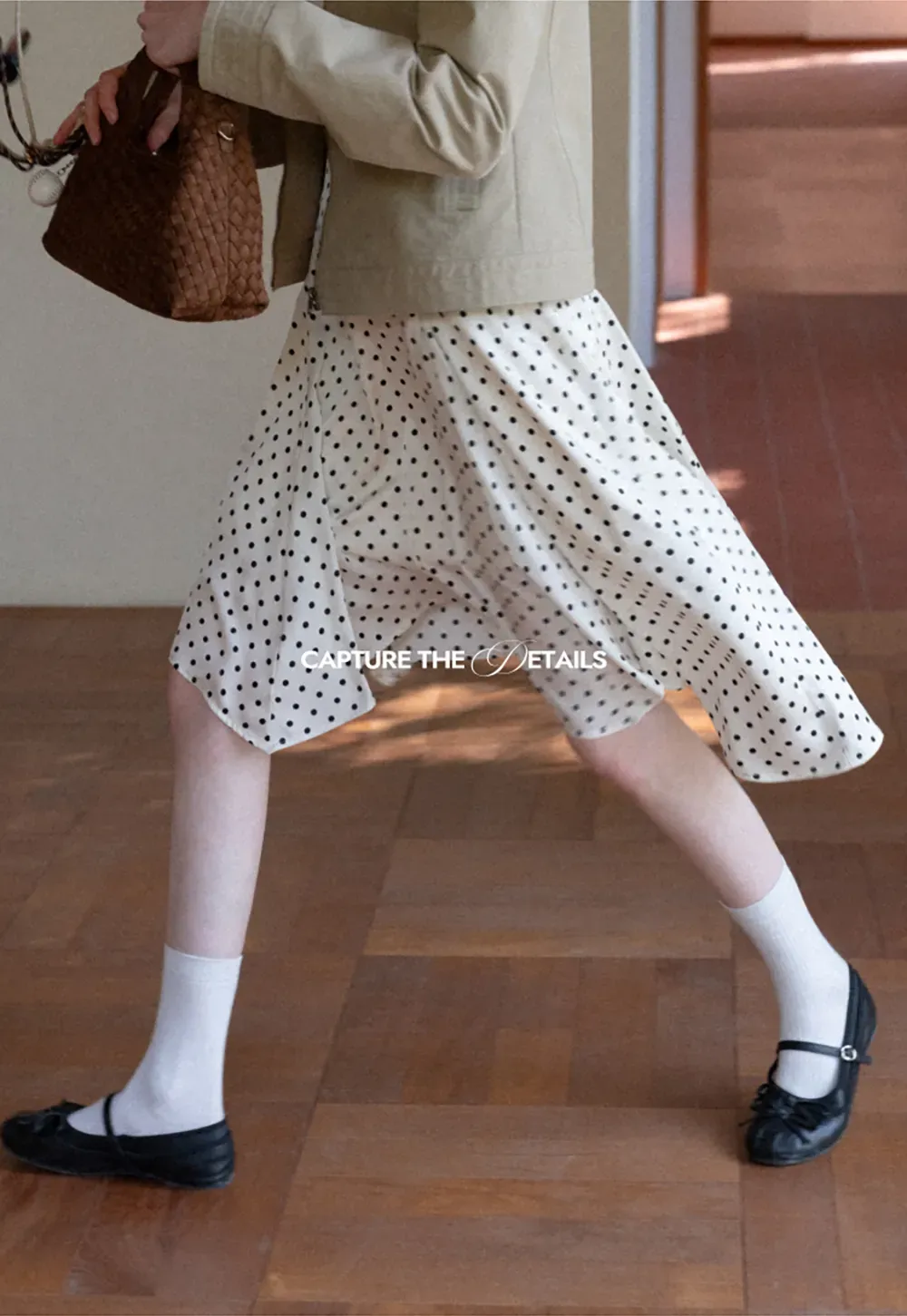 Polka dot asymmetrical hem skirt with pleats