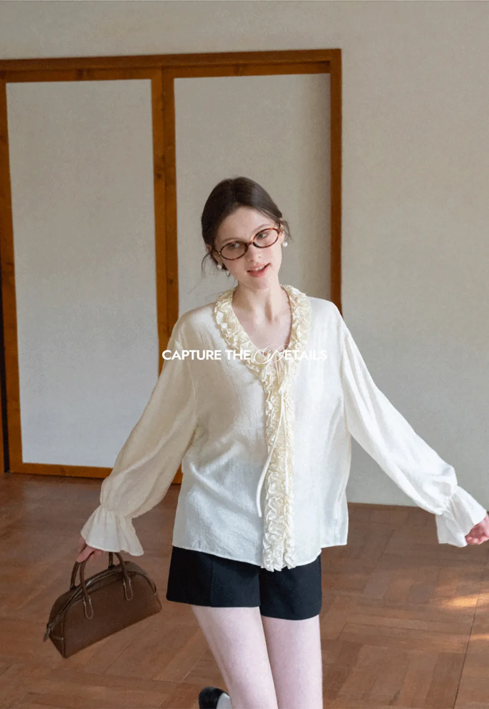 Long sleeve shirt with ruffled neckline and gathered cuffs