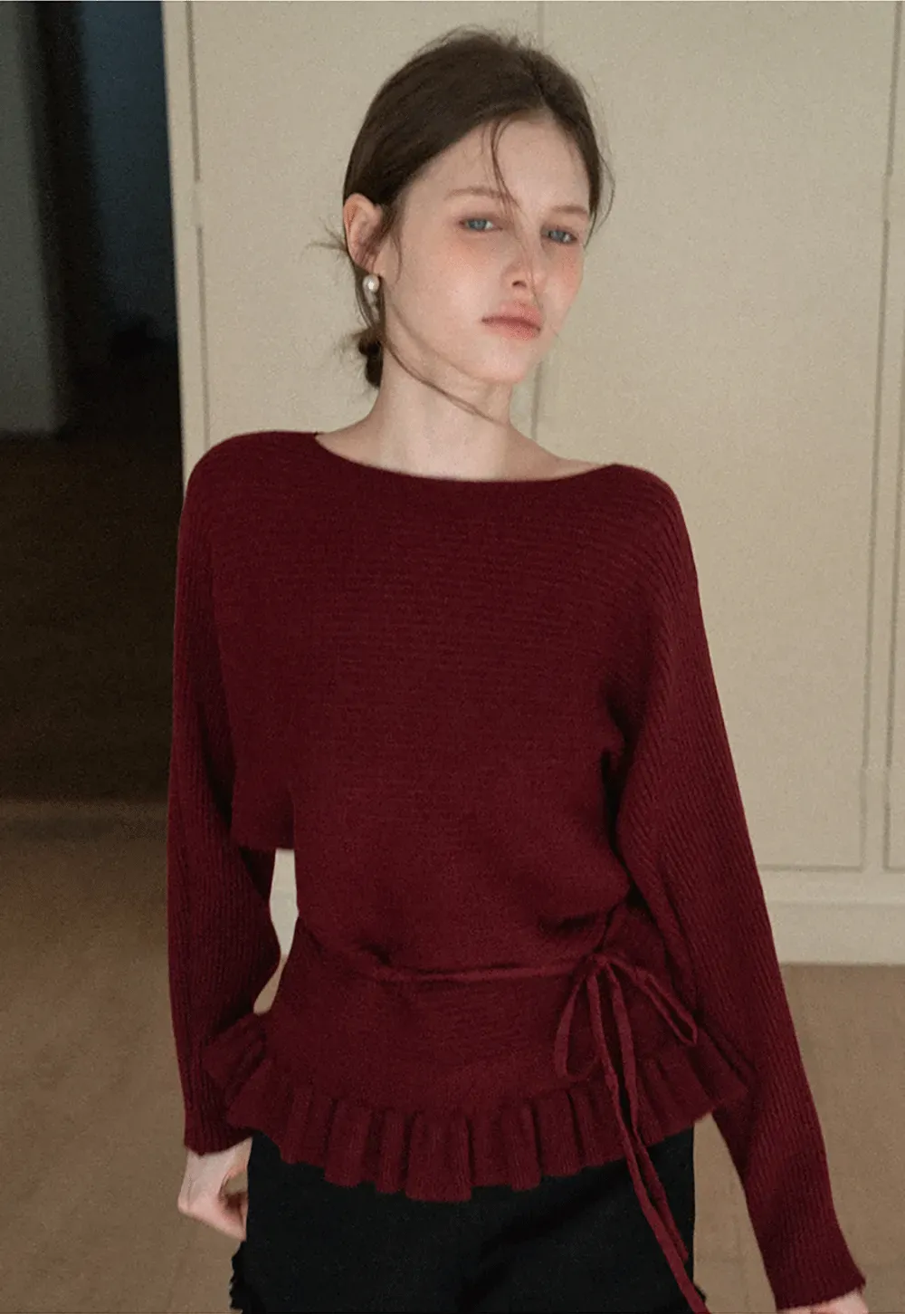 Ribbed knit sweater with tie back and flared hem design