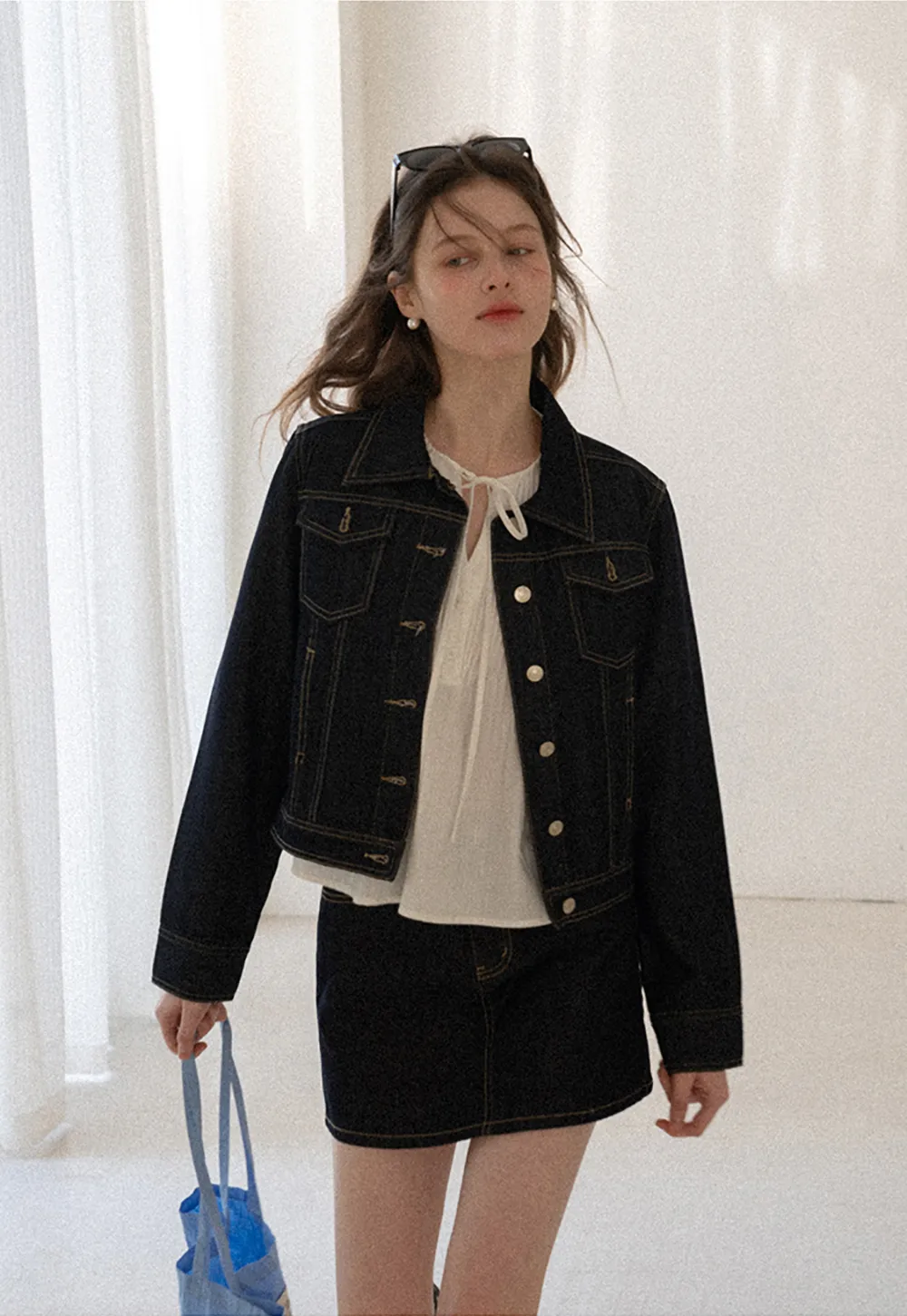 A-line denim skirt with front pocket design and adjustable waistband.