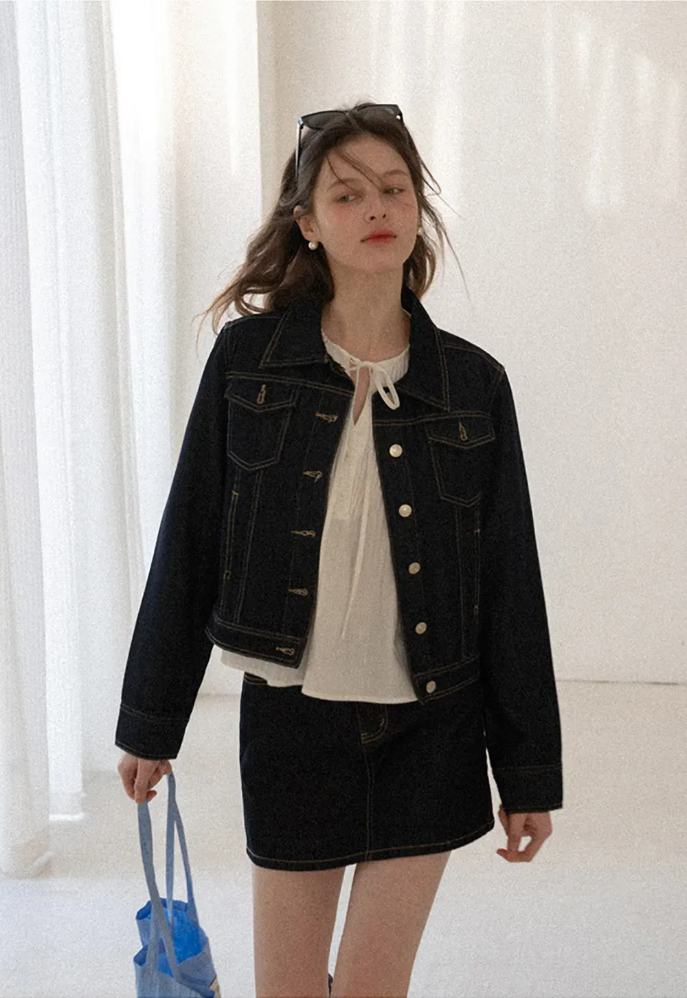 A-line denim skirt with front pocket design and adjustable waistband.