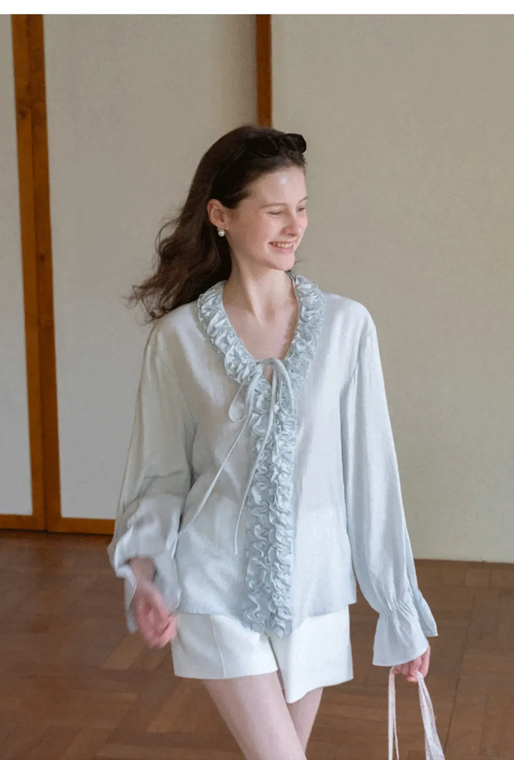 Long sleeve shirt with ruffled neckline and gathered cuffs