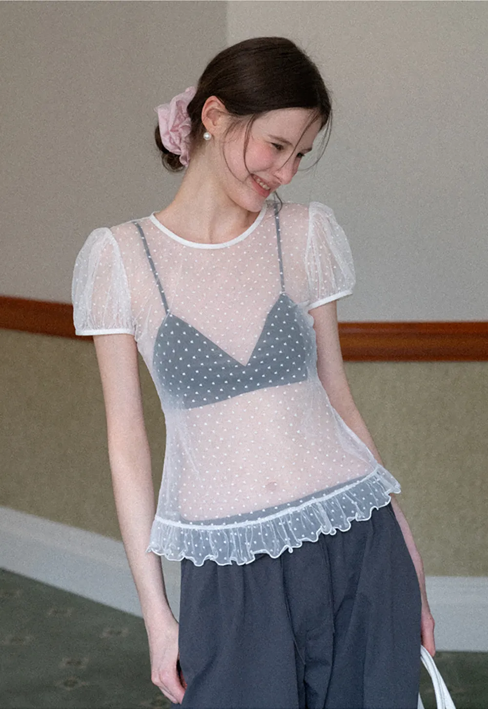 Sheer polka dot top with ruffled hem and puff sleeves