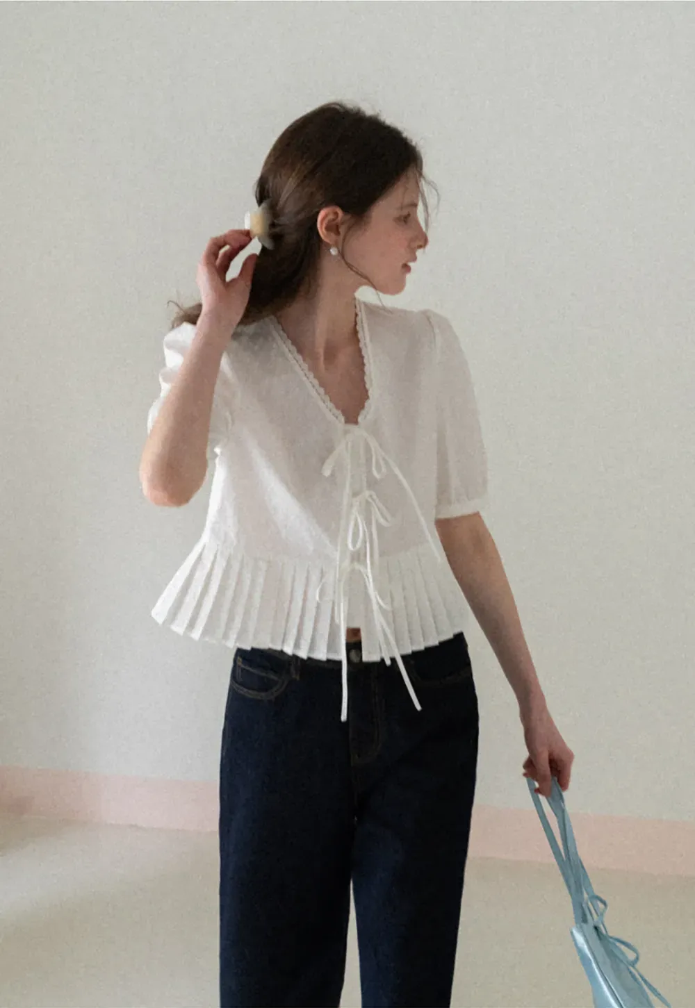 V neck short sleeve blouse with pleated hem and tie front