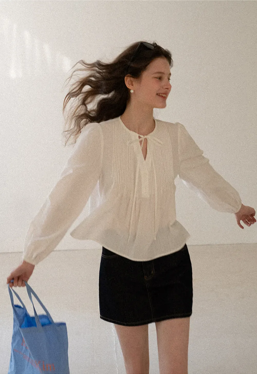 A-line denim skirt with front pocket design and adjustable waistband.