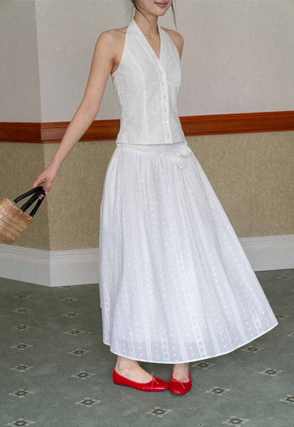 Halter neck sleeveless top with buttons and pleated skirt