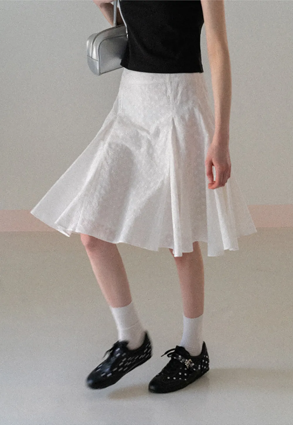 Flared pleated skirt with subtle texture