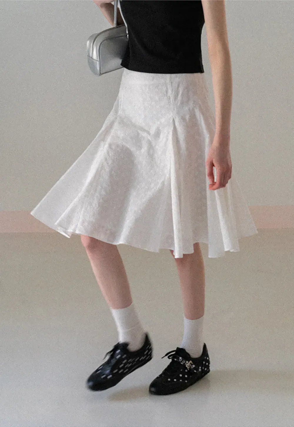 Flared pleated skirt with subtle texture