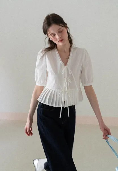 V neck short sleeve blouse with pleated hem and tie front