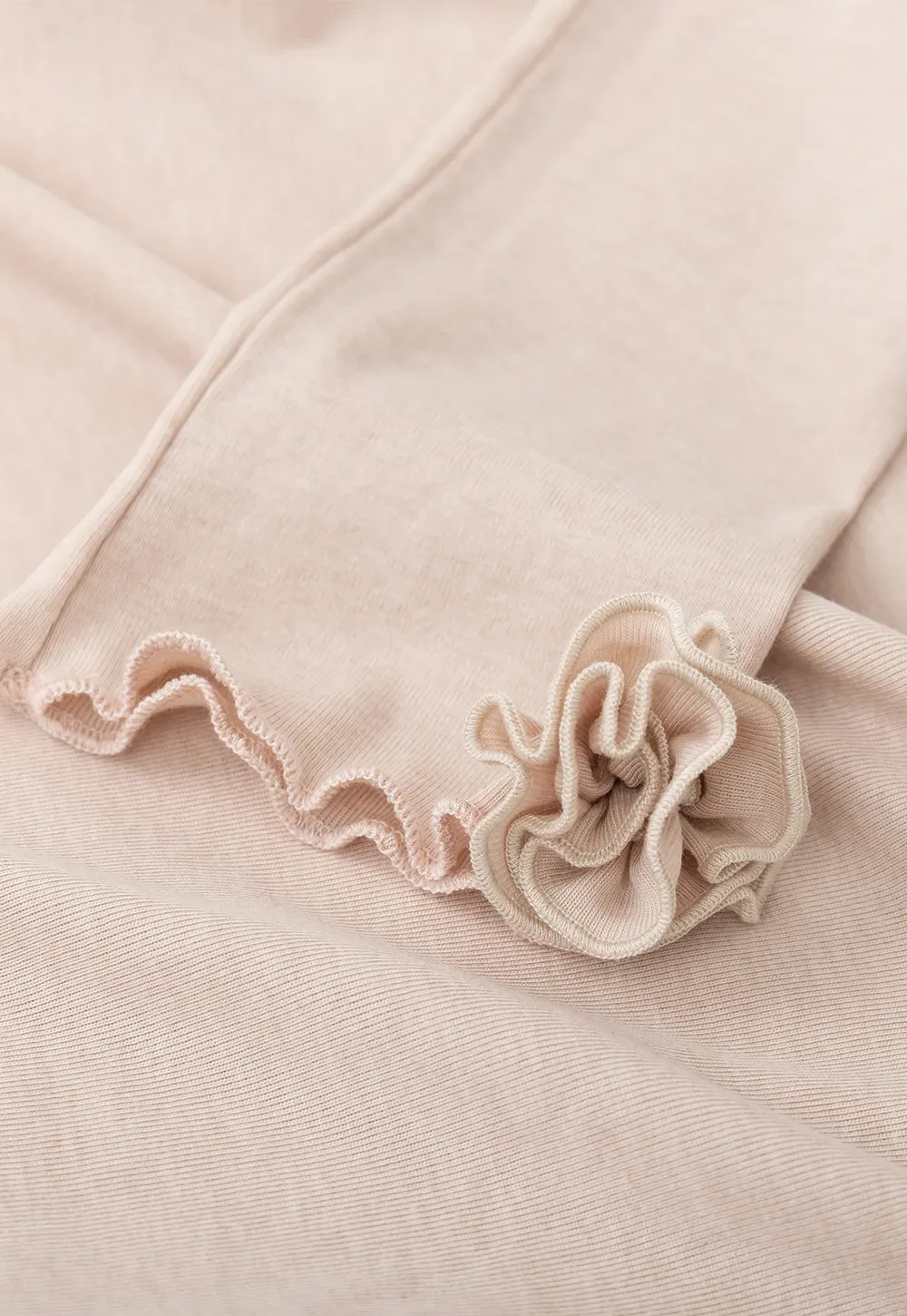 Long sleeve top with ruffled hem and cuffs