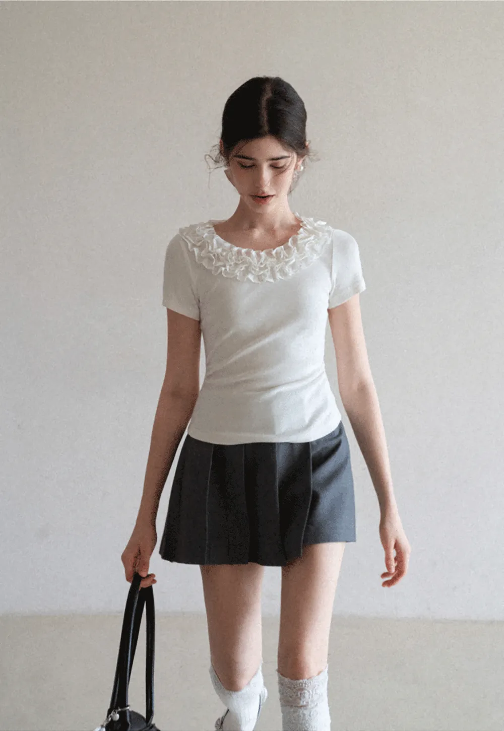 Short sleeve knit top with ruffled neckline
