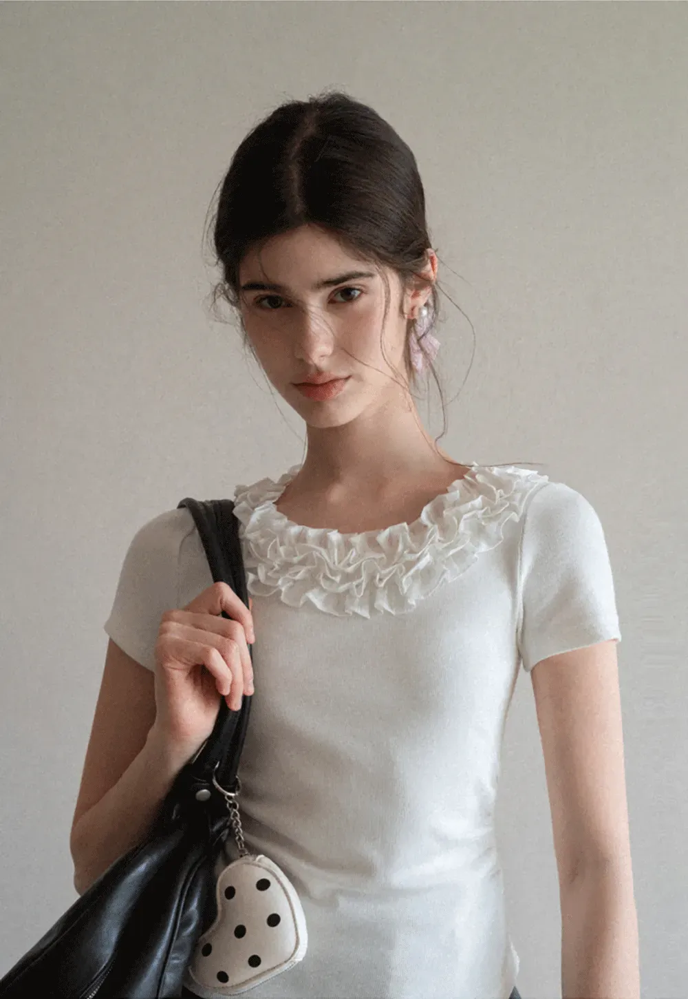 Short sleeve knit top with ruffled neckline