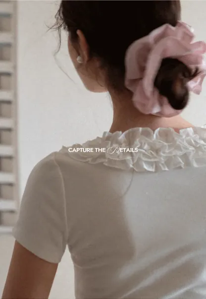 Short sleeve knit top with ruffled neckline