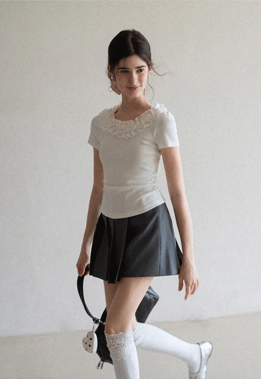 Short sleeve knit top with ruffled neckline