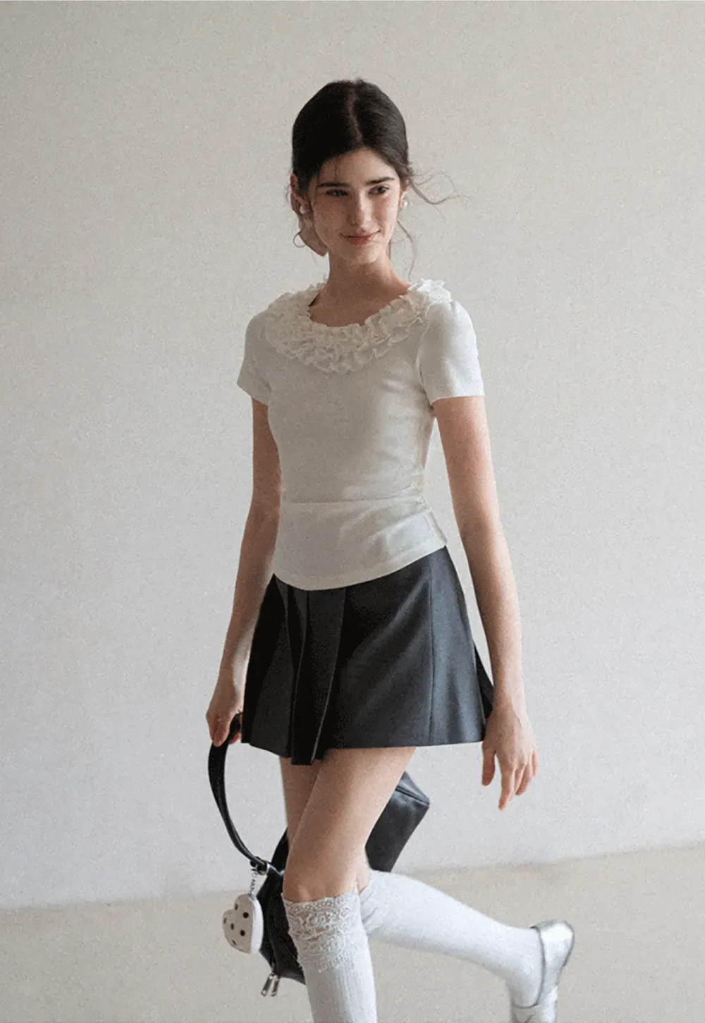 Short sleeve knit top with ruffled neckline