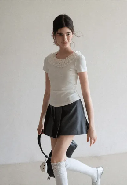 Short sleeve knit top with ruffled neckline