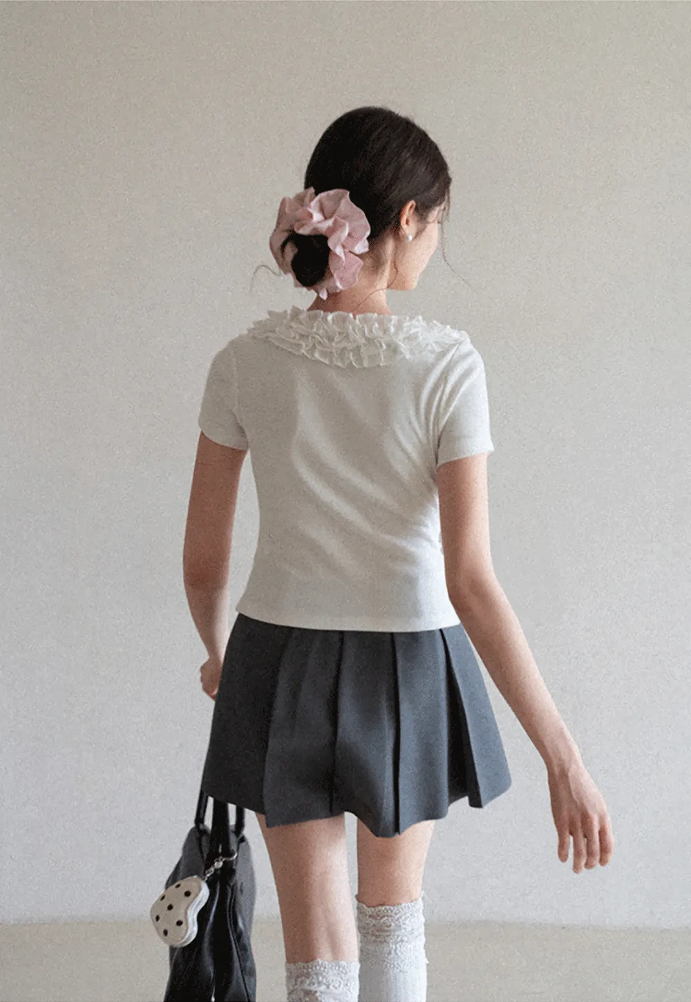 Short sleeve knit top with ruffled neckline