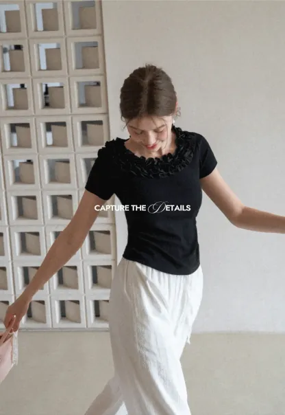 Short sleeve knit top with ruffled neckline