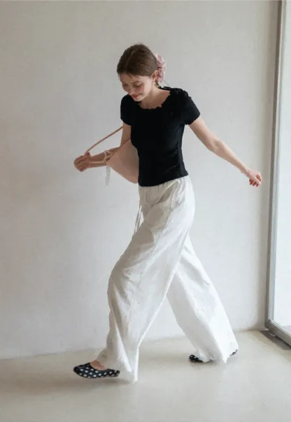 Short sleeve knit top with ruffled neckline