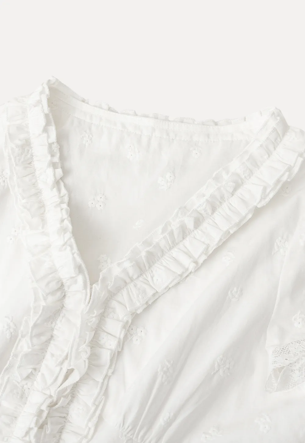 Embroidered short sleeve top with ruffled V neck and lace trim