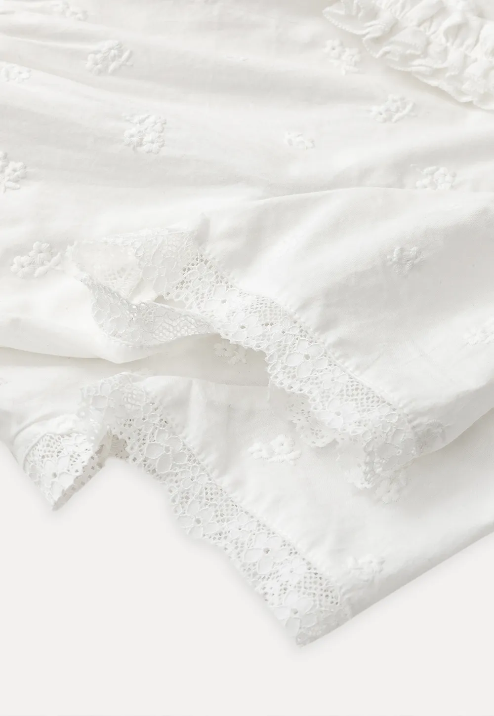 Embroidered short sleeve top with ruffled V neck and lace trim