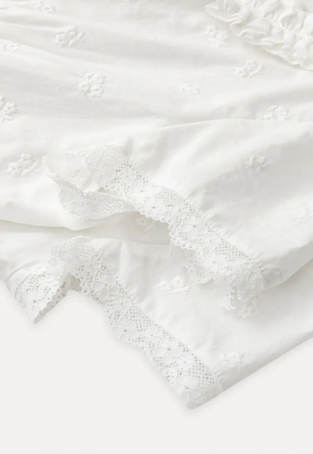 Embroidered short sleeve top with ruffled V neck and lace trim