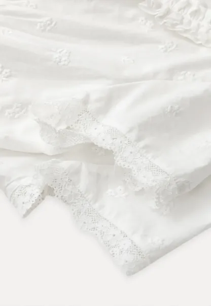 Embroidered short sleeve top with ruffled V neck and lace trim