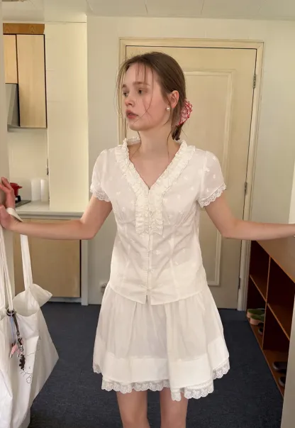 Embroidered short sleeve top with ruffled V neck and lace trim