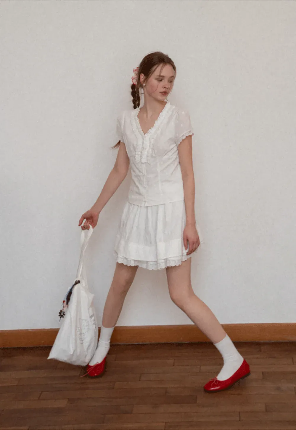 Embroidered short sleeve top with ruffled V neck and lace trim