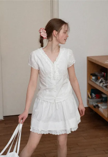 Embroidered short sleeve top with ruffled V neck and lace trim