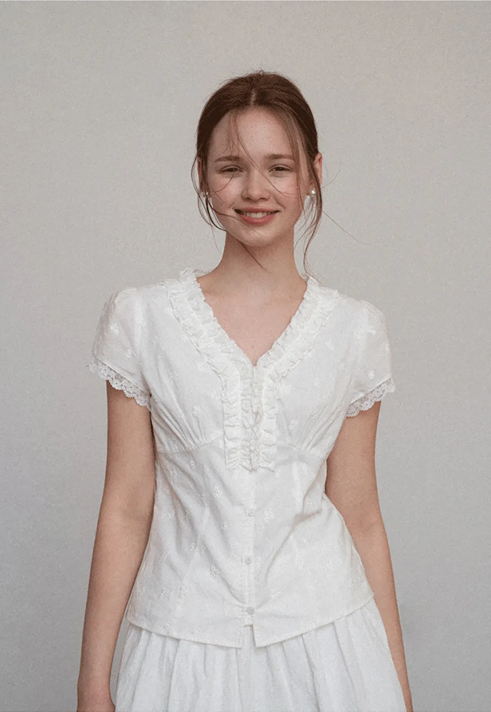Embroidered short sleeve top with ruffled V neck and lace trim