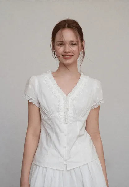 Embroidered short sleeve top with ruffled V neck and lace trim