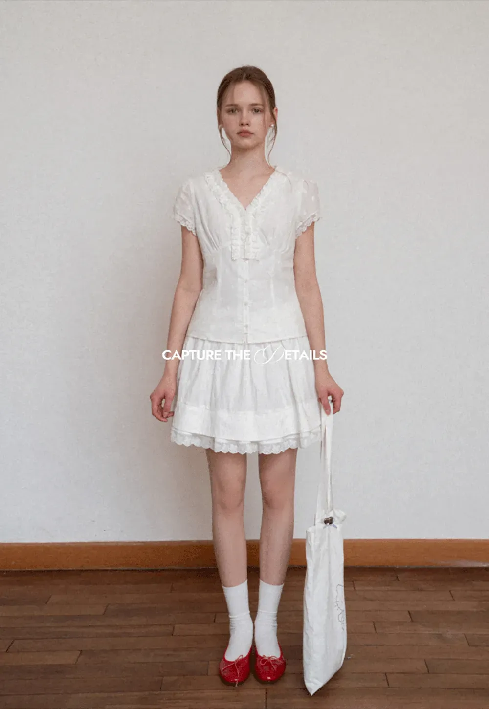 Embroidered short sleeve top with ruffled V neck and lace trim