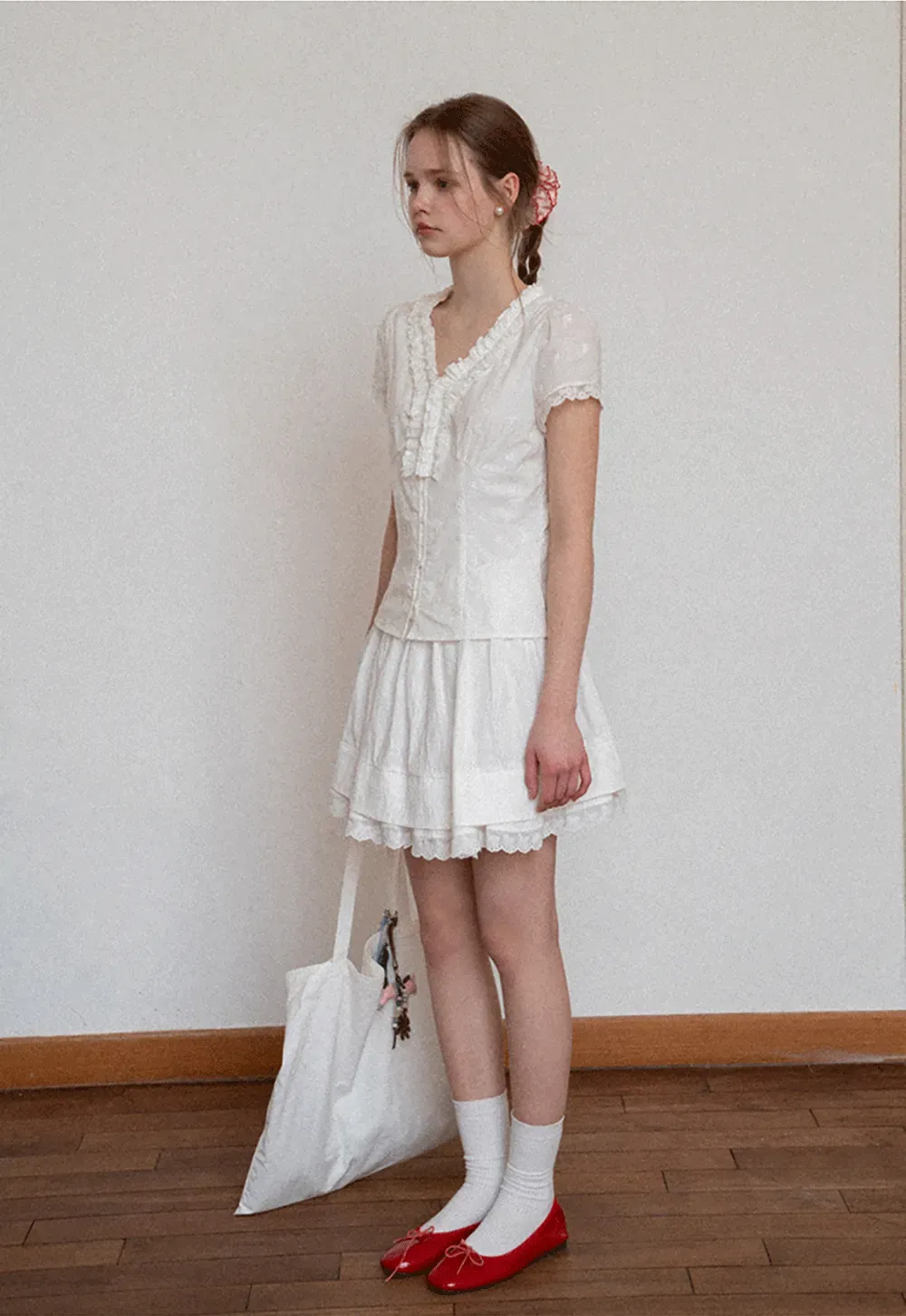 Embroidered short sleeve top with ruffled V neck and lace trim