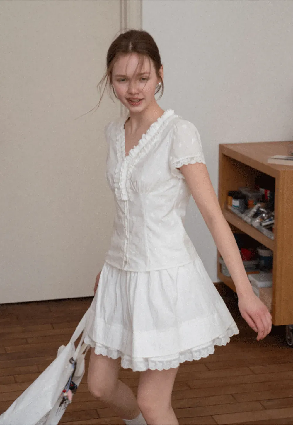 Embroidered short sleeve top with ruffled V neck and lace trim