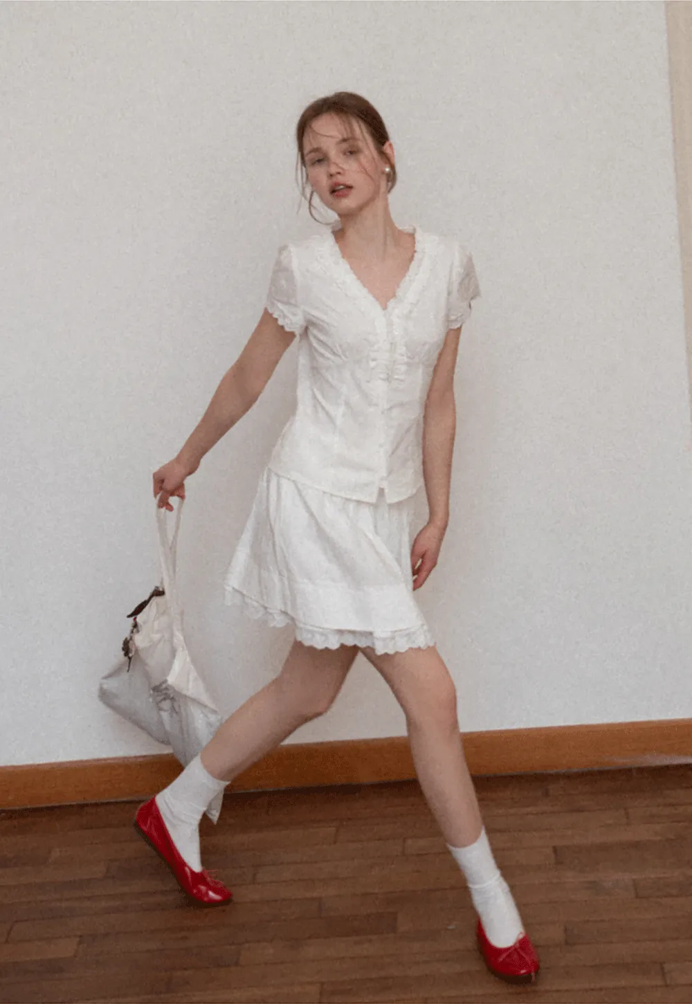 Embroidered short sleeve top with ruffled V neck and lace trim