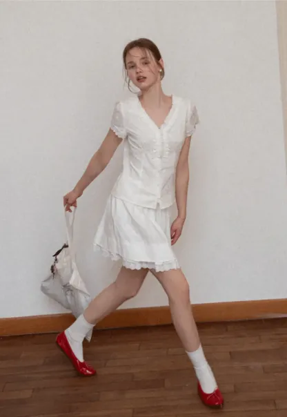 Embroidered short sleeve top with ruffled V neck and lace trim