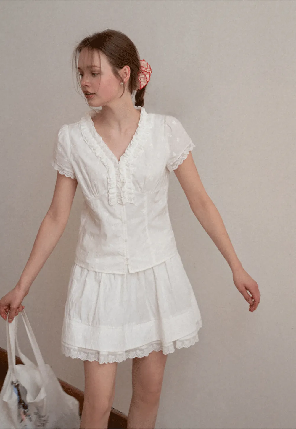 Embroidered short sleeve top with ruffled V neck and lace trim