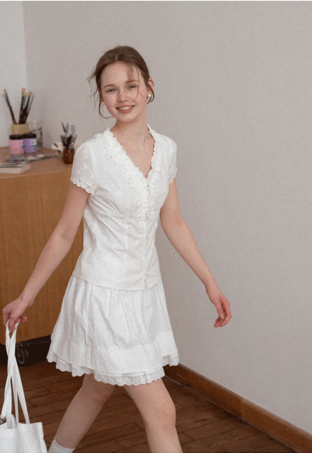 Embroidered short sleeve top with ruffled V neck and lace trim