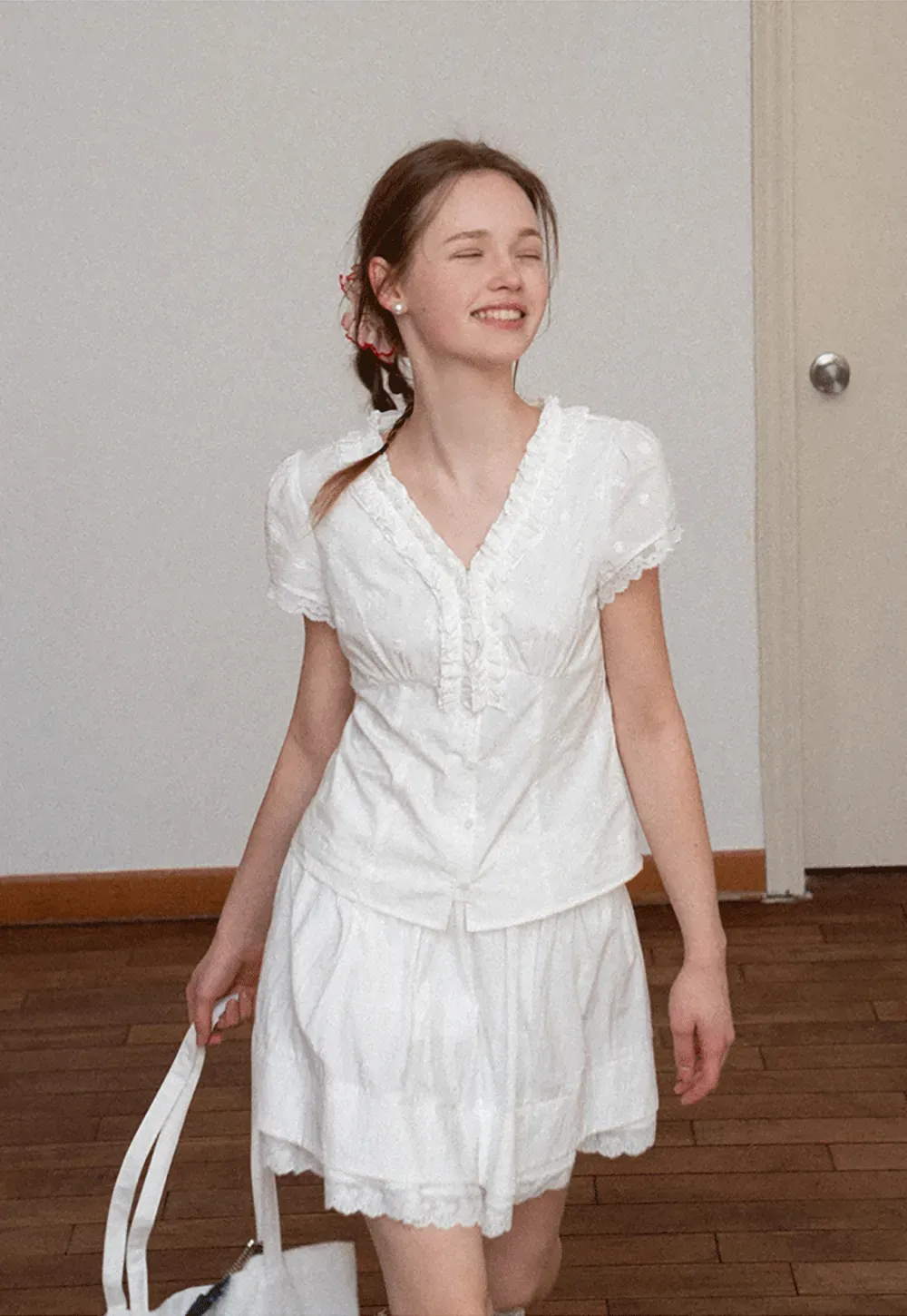 Embroidered short sleeve top with ruffled V neck and lace trim