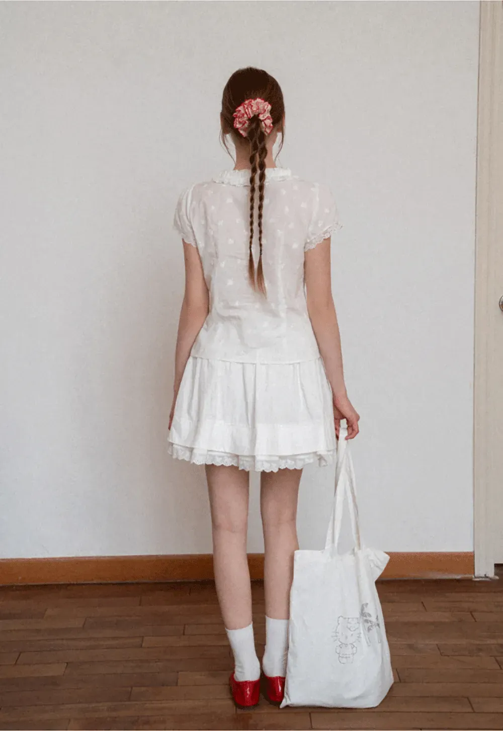 Embroidered short sleeve top with ruffled V neck and lace trim