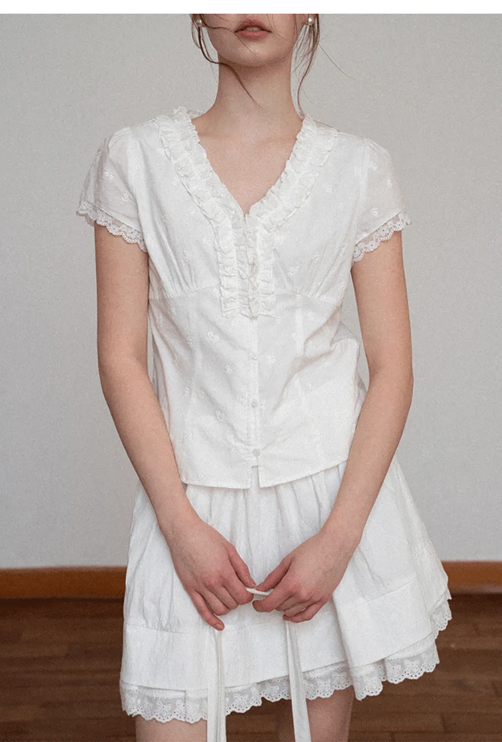 Embroidered short sleeve top with ruffled V neck and lace trim